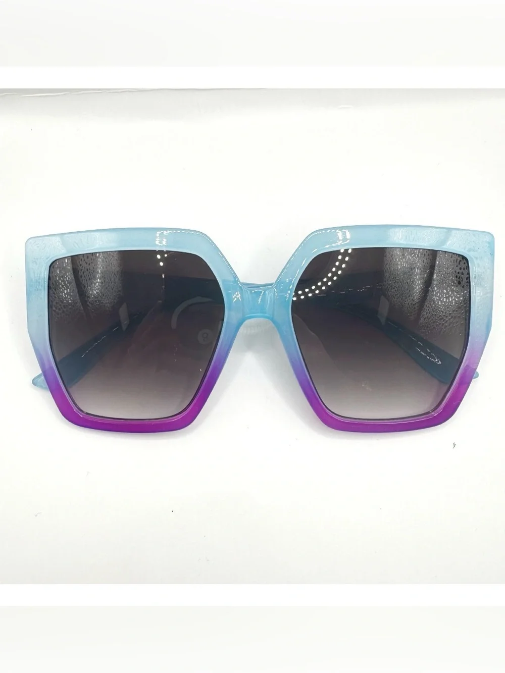 Oversized square women's sunglasses featuring a vibrant light blue-to-purple